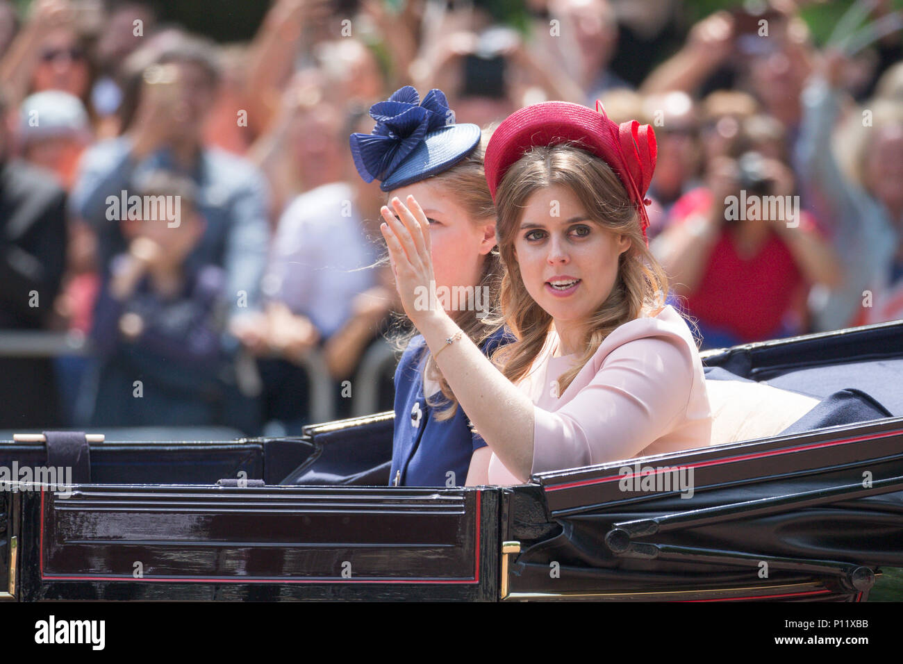 Picture dated June 9th shows  Princess Beatrice of York (red hat) and Lady Louise Windsor at the Trooping the Colour in London today.  The Duke and Duchess of Sussex have joined the Queen for the Trooping the Colour parade to mark her 92nd birthday.  Print Harry and Meghan Markle, who married last month, arrived as part of the carriage procession.  Large crowds of spectators gathered to watch Saturday's ceremony, which saw around 1,000 soldiers march to Horse Guards Parade in Whitehall. Stock Photo