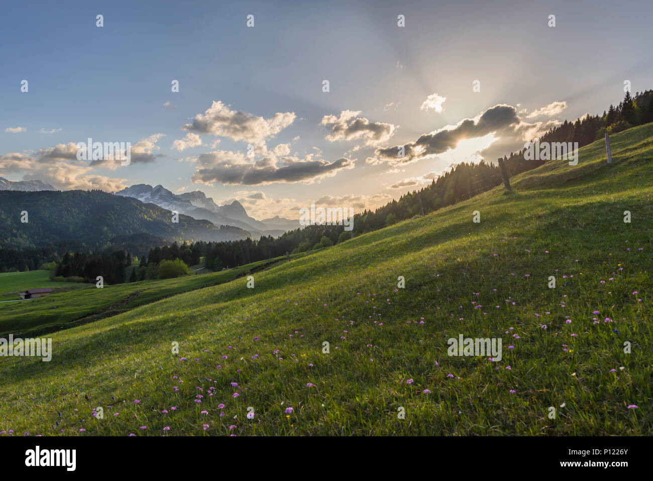 Mount Alpspitze, Mount Zugspitze and Waxenstein of the Wetterstein mountains with clouds just before sunset, Bavaria, Germany Stock Photo