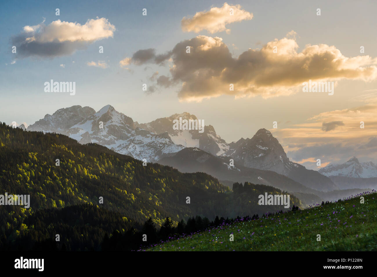 Mount Alpspitze, Mount Zugspitze and Waxenstein of the Wetterstein mountains with clouds just before sunset, Bavaria, Germany Stock Photo