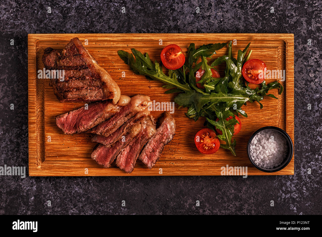 https://c8.alamy.com/comp/P123NT/beef-steak-on-a-dark-background-top-view-copy-space-P123NT.jpg