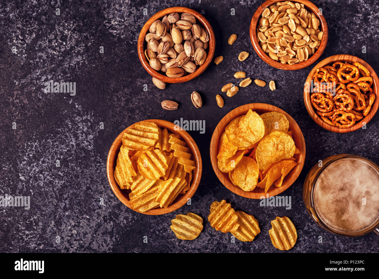 Beer with snacks on stone background. Top view, copy space. Stock Photo