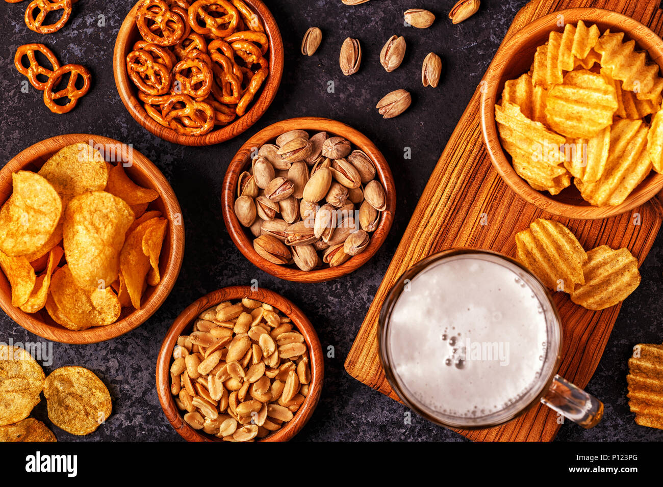 Beer with snacks on stone background. Top view, copy space. Stock Photo