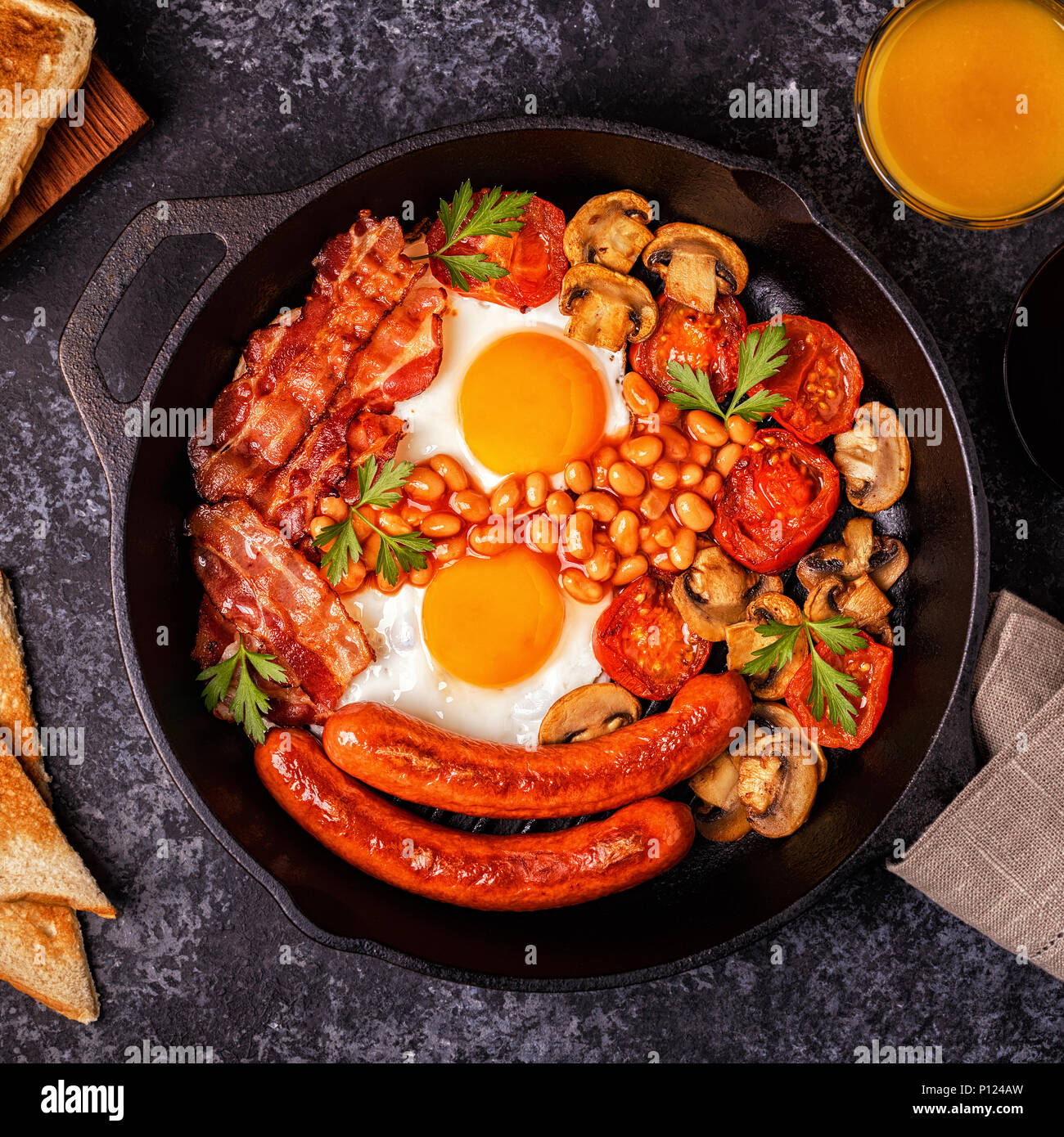 Traditional full English breakfast with fried eggs, sausages, beans
