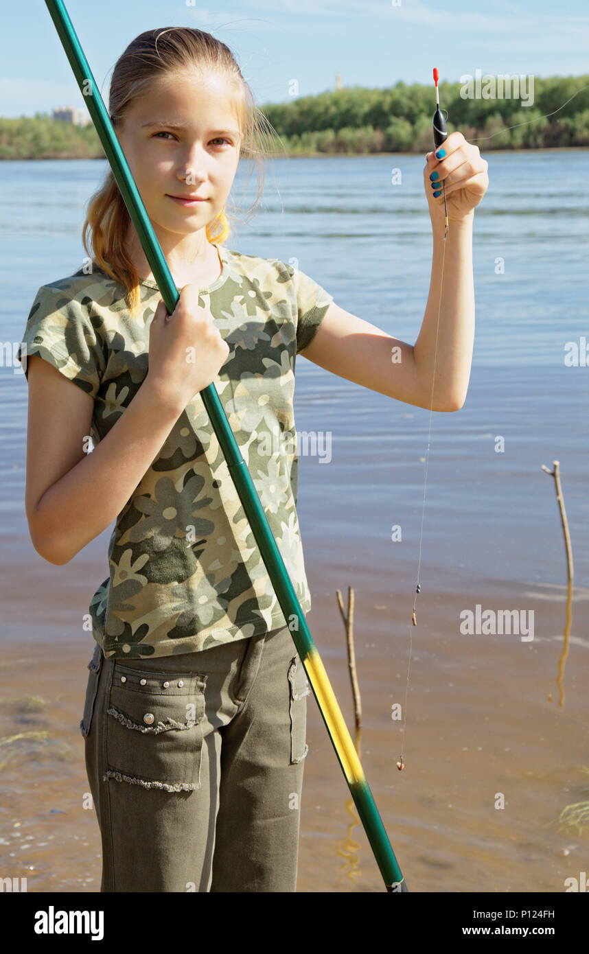 Teen fisherman prepares the bait to throw the bait in the river water