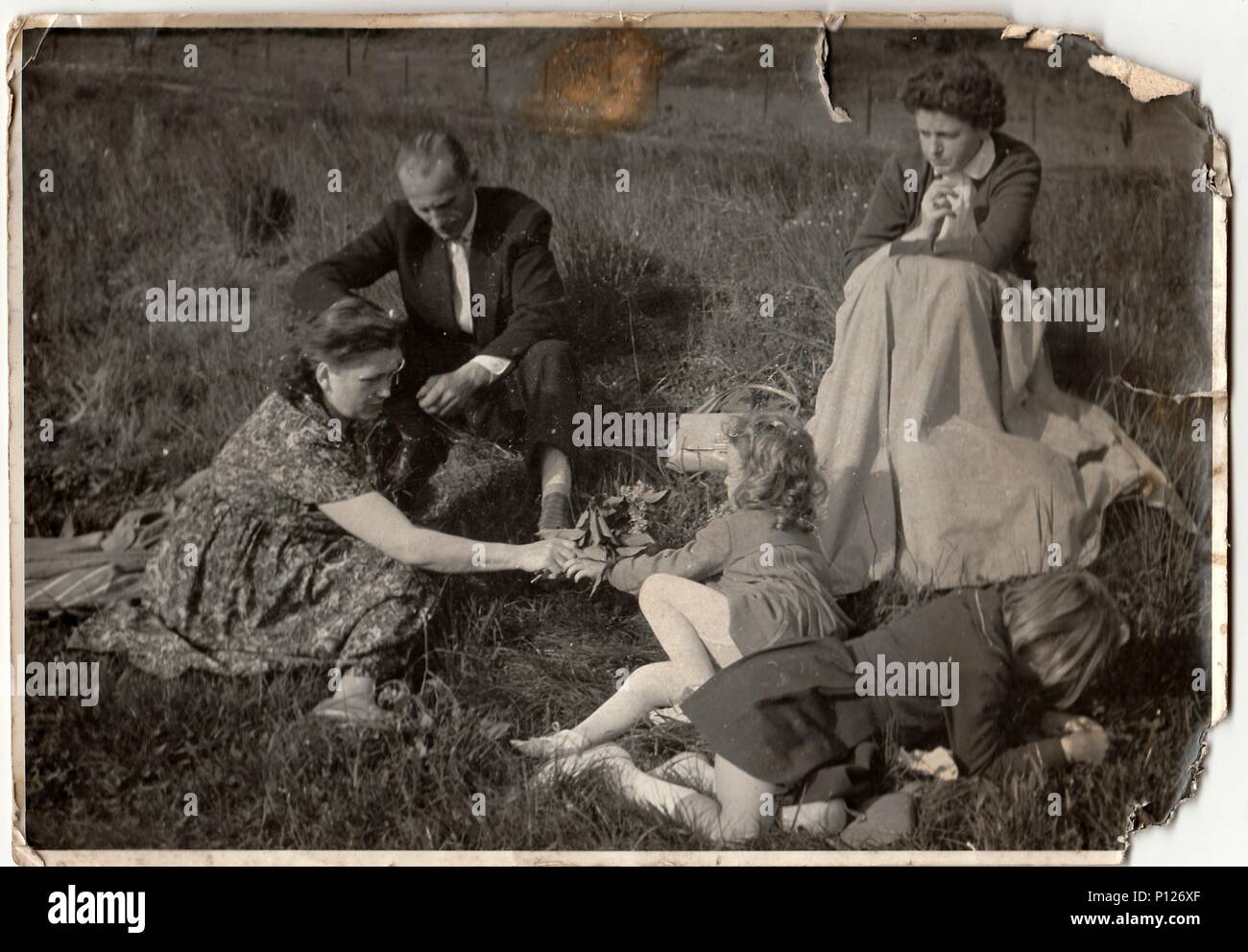 THE CZECHOSLOVAK SOCIALIST REPUBLIC - CIRCA 1960s:  Vintage photo shows family on meadow. Stock Photo