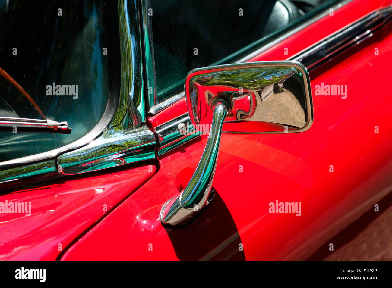 rear mirror, car mirror closeup on red oldtimer car Stock Photo