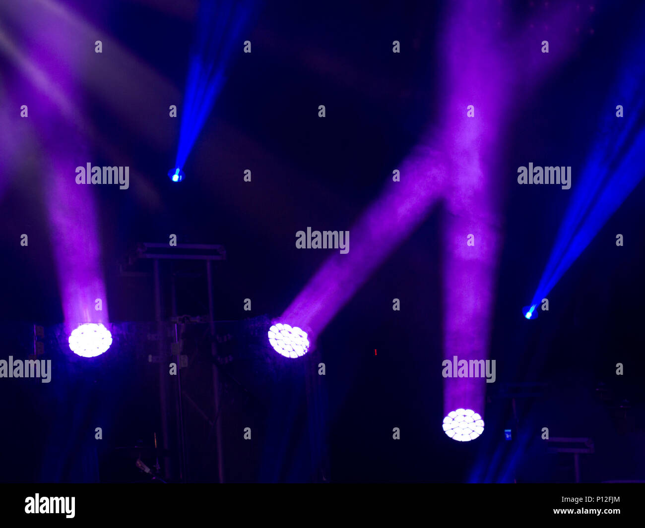 Soffits during show, robots letting blue rays on professional dark scene Stock Photo