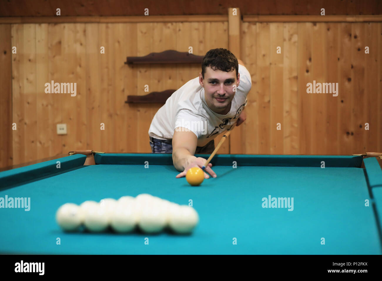 man plays billiards and takes aim before the turn Stock Photo - Alamy