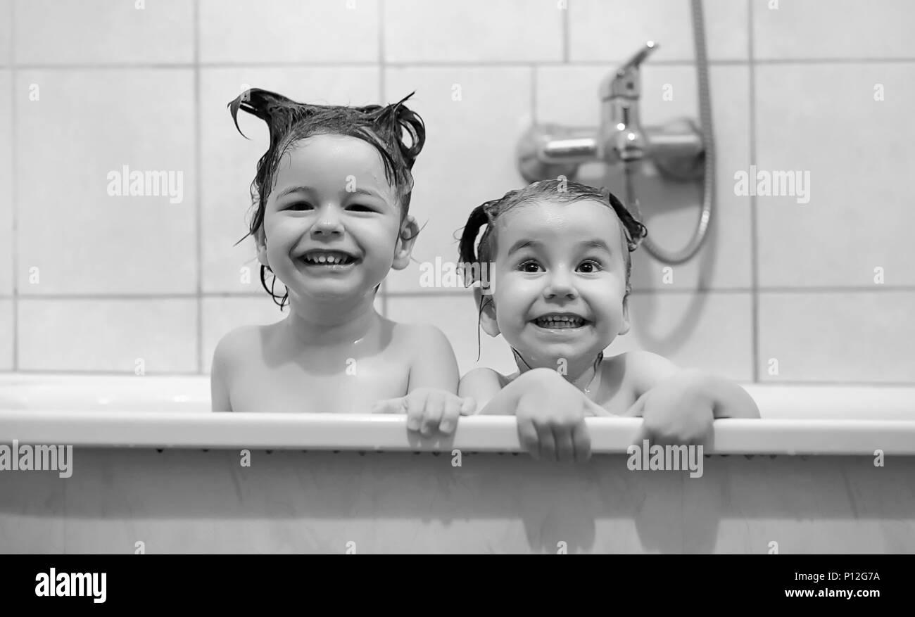 Young children take a bath. Children wash in bathroom. Brother and