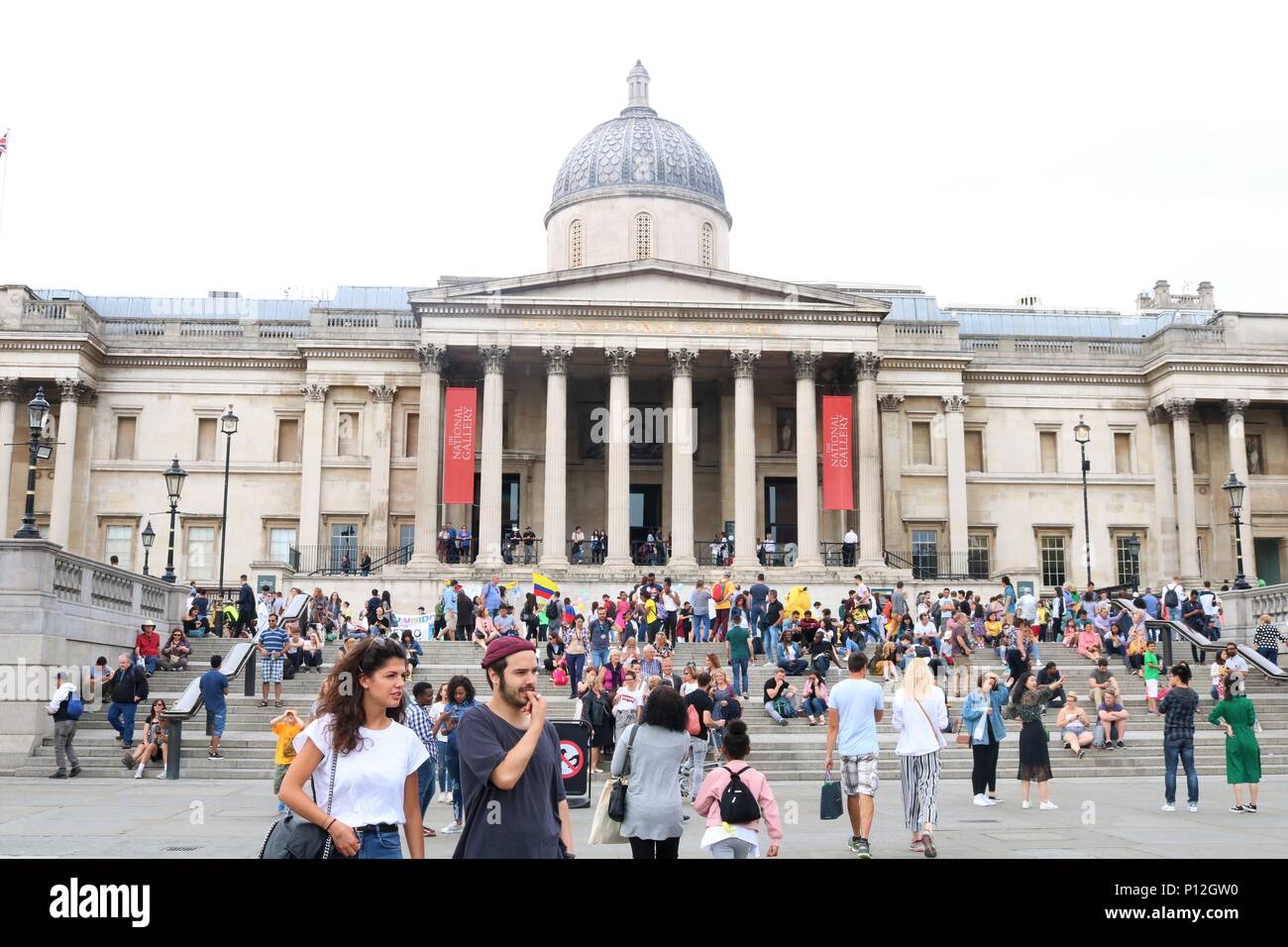 People enjoying the sunny weather at Trafalgar Square, London, UK Stock Photo