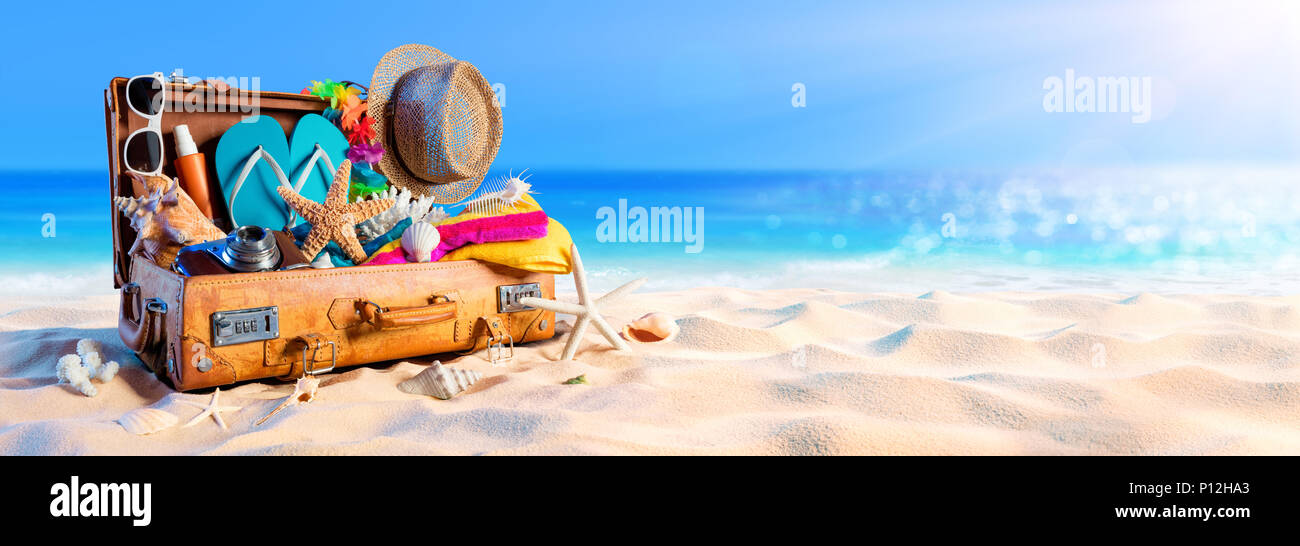 Beach Preparation - Accessories In Suitcase On Sand Stock Photo
