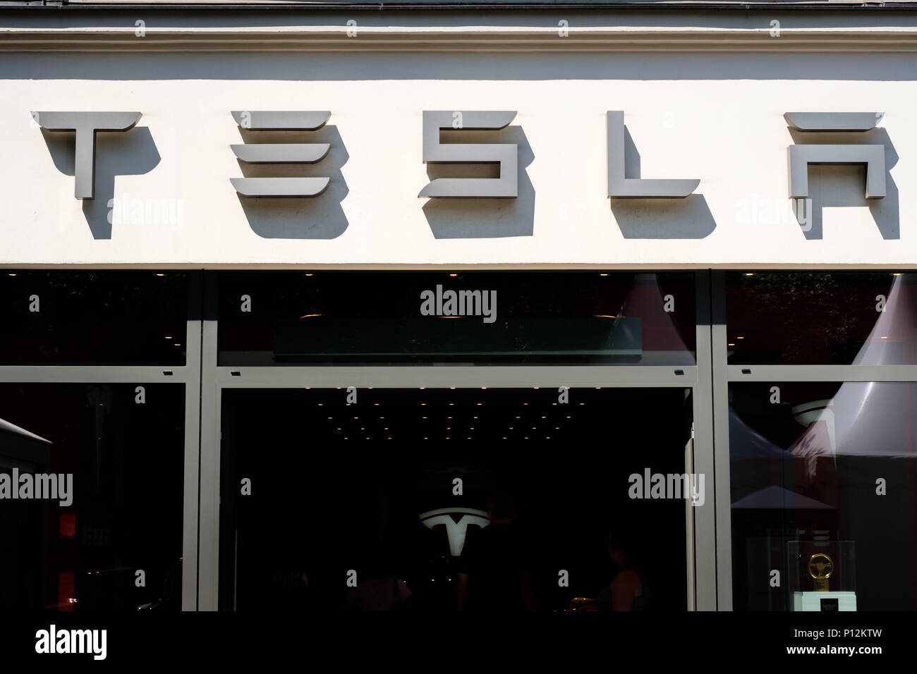 Berlin, Germany - june  2018: Tesla logo / brand name on shop facade in Berlin. Tesla, Inc.  is an American multinational corporation specialized in e Stock Photo