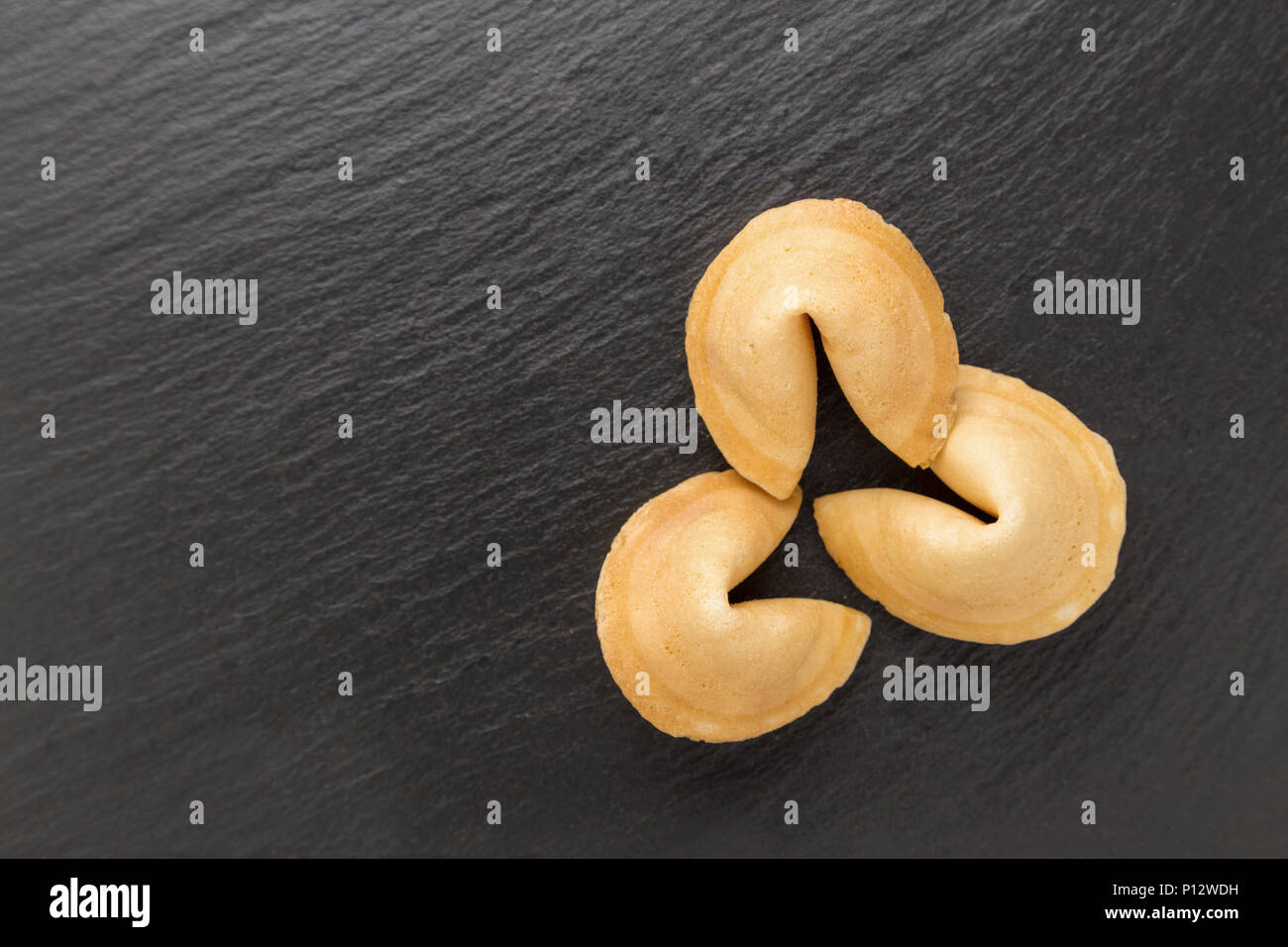 traditional Chinese pastry with the wishes or predictions on a black background Stock Photo