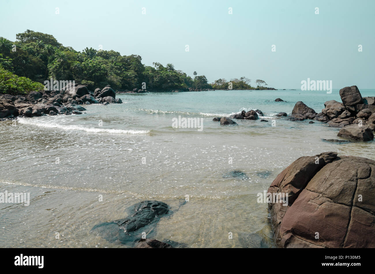 Black Johnson Beach in Sierra Leone, Africa with calm sea, ropcks, and deserted beach Stock Photo