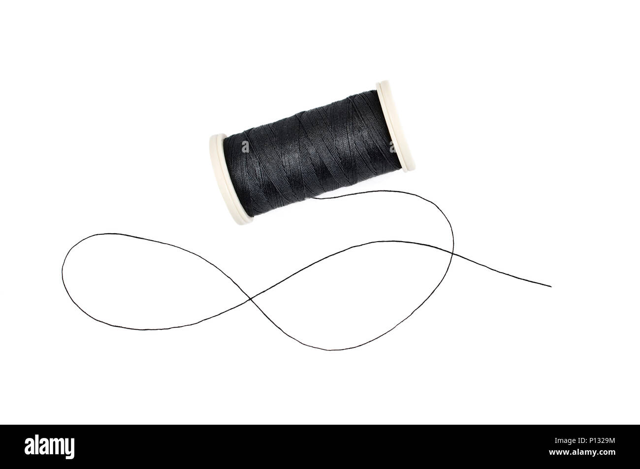 Spool of sewing thread on white background Stock Photo - Alamy
