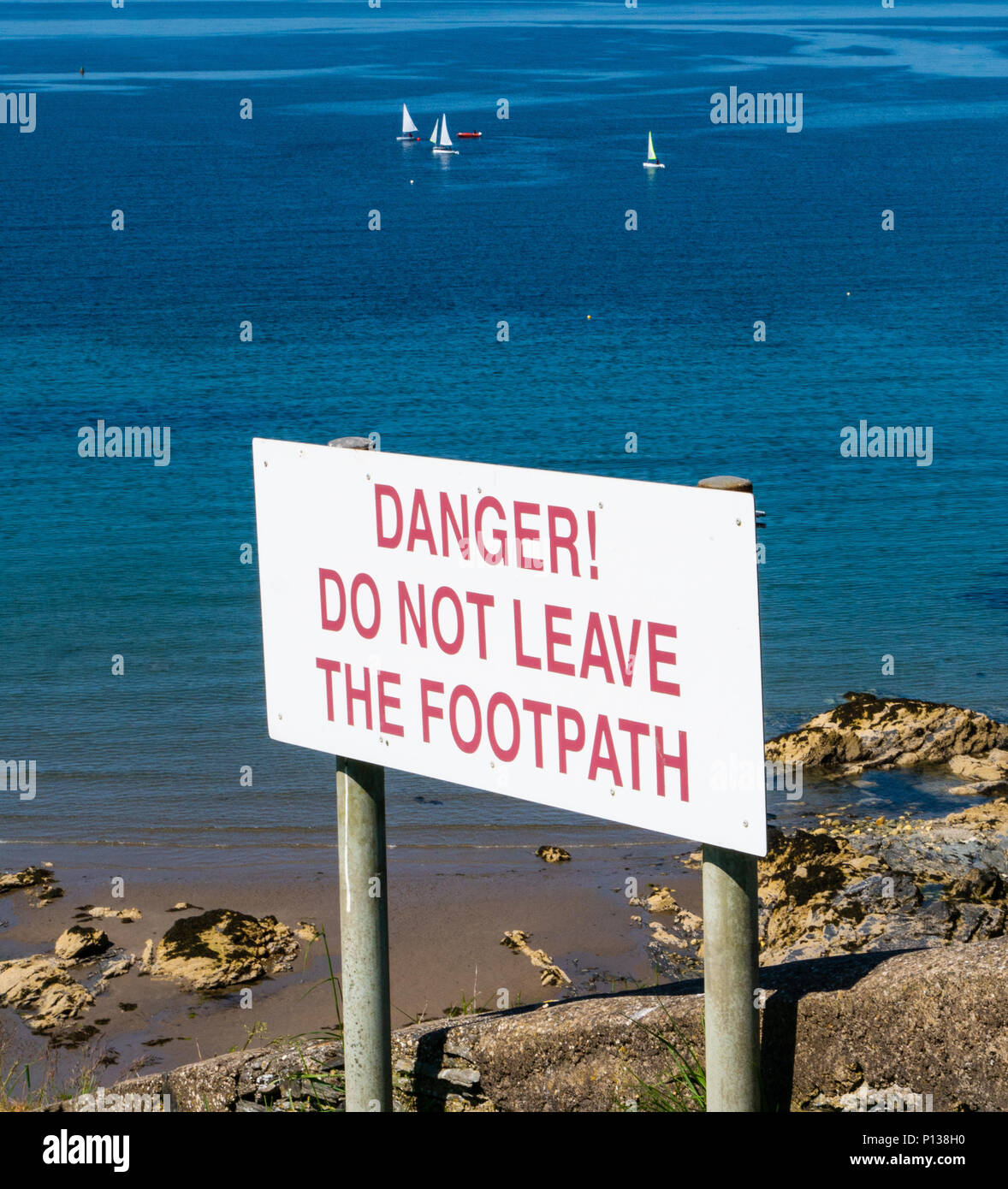 Danger! Do Not Leave the Footpath - sign on a cliff at Port Erin, Isle of Man Stock Photo