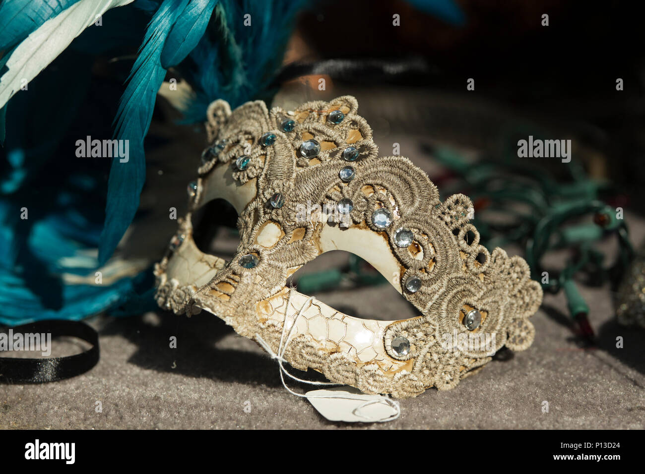 A beaded and lace Mardi Gras mask in a shop window in the French