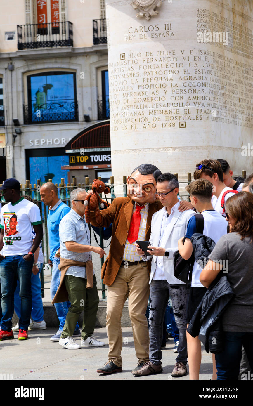 Audience watching street entertainers, with Mr Bean character, Plaza de Puerta del Sol, Madrid, Spain. May 2018 Stock Photo