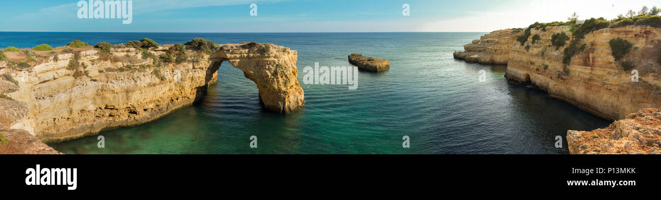 Panoramic view of the natural arch Arco  da Albandeira in the Algarve, Portugal. Stock Photo