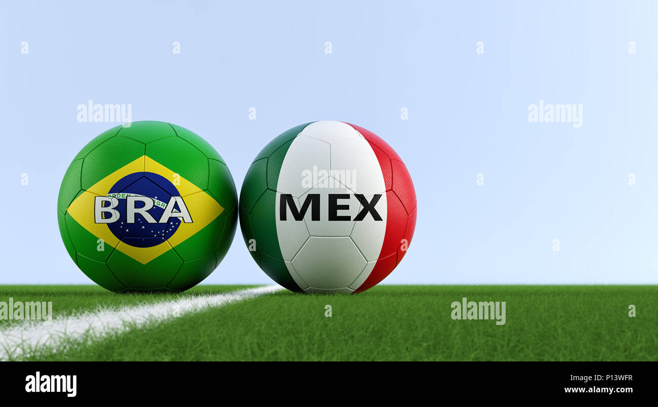 Brazil vs. Mexico Soccer Match - Soccer balls in Brazils and Mexicos national colors on a soccer field. Copy space on the right side Stock Photo