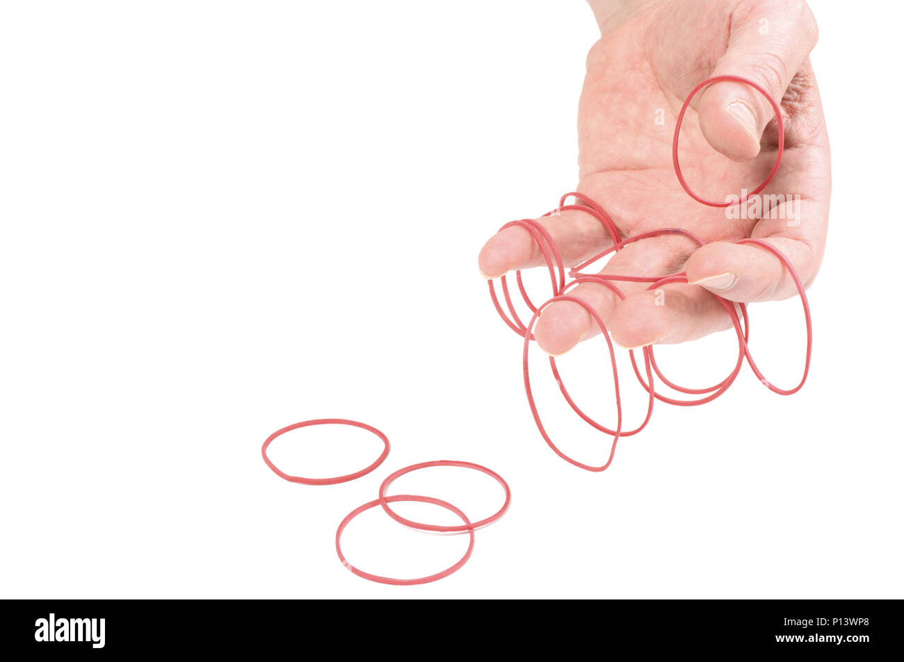 Rubber bands in human hand. Isolated on white background. Stock Photo