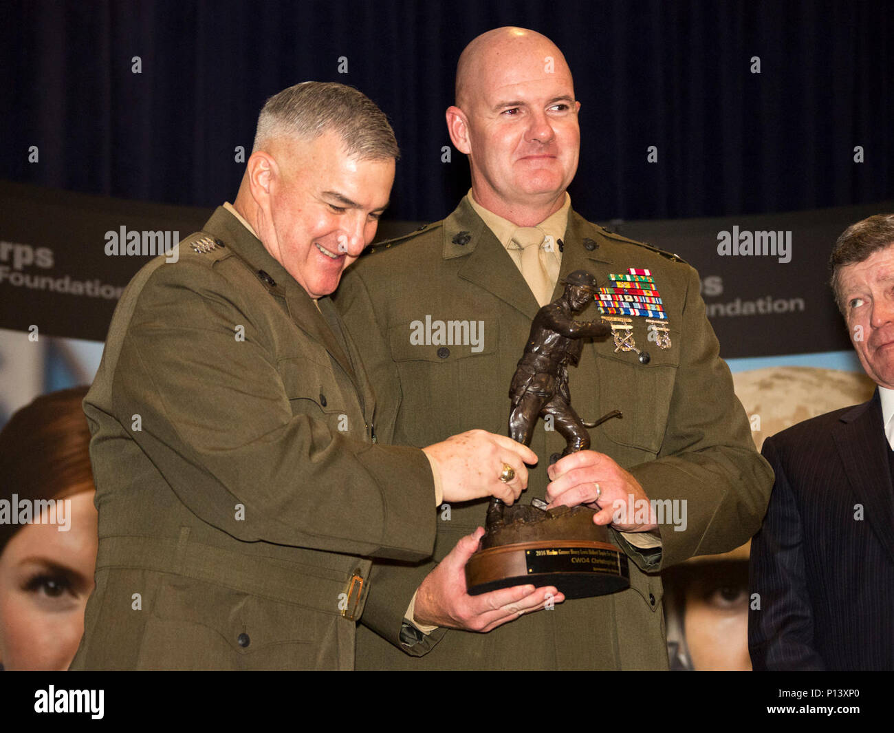 U.S. Marine Corps Gen. Glenn M. Walters, left, 34th assistant commandant of the Marine Corps, awards Chief Warrant Officer 4 Christopher Jones, recipient of the Marine Gunner Henry Lewis Hulbert award, during the Marine Corps Association and Foundation 14th Annual Ground Awards Dinner, May 4, 2017. Walters was the guest speaker and presented awards to nine Marines during the event. Stock Photo