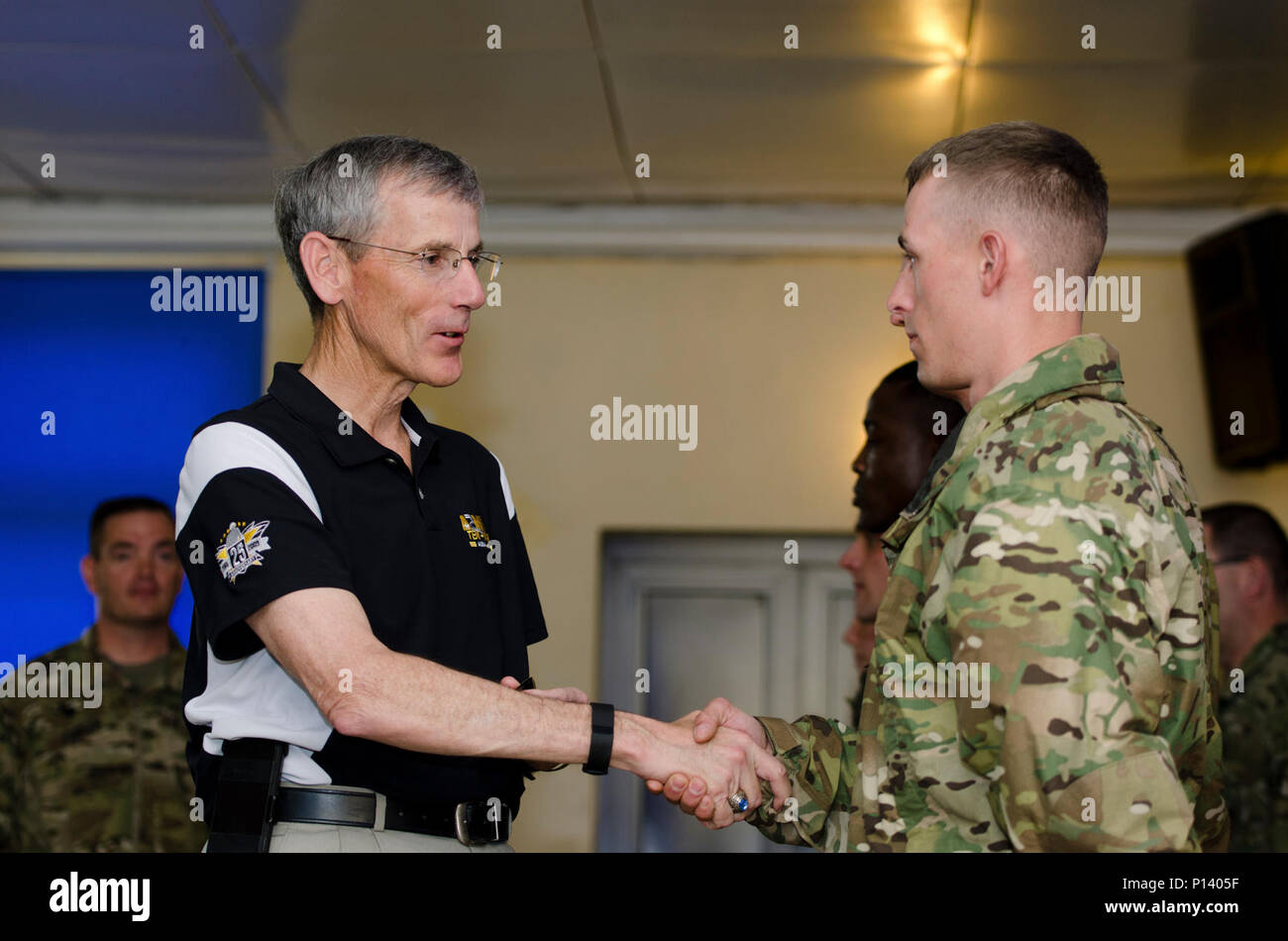 Acting Secretary of the Army, Mr. Robert M. Speer, presents a coin to a soldier from the 497th Combat Sustainment Support Battalion during his visit to Powidz, Poland on May 6, 2017. The 497th CSSB provides logistical support for Operation Atlantic Resolve, a U.S.-led effort to strengthen the NATO alliance and deter aggression in the region. Stock Photo