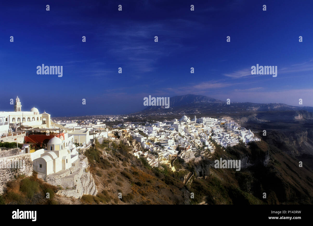 Greek Island of Thira (Santorini), view of the cliffs, looking south, showing the town of Thira along the cliff's edge with late light, Greece Stock Photo