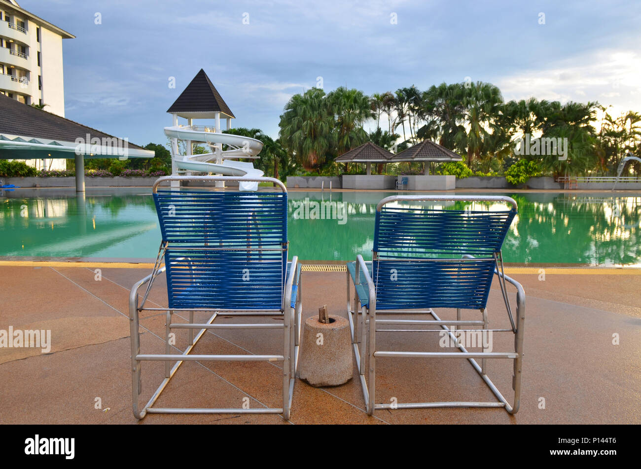 Beach chairs near swimming pool in tropical resort Stock Photo Alamy
