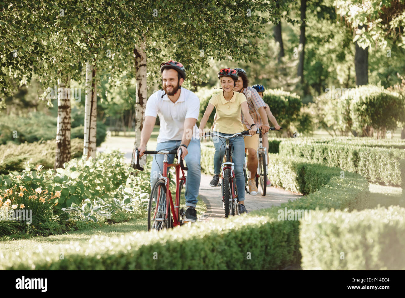 Cute Sporty Friends Riding Bikes In Park Group Of Friendly Students Spending Time Together Outside Summer Vacation Concept Cute Sporty Friends Riding Bikes In Park Group Of Friendly Students Spending Time Together Outside Summer Vacation Concept