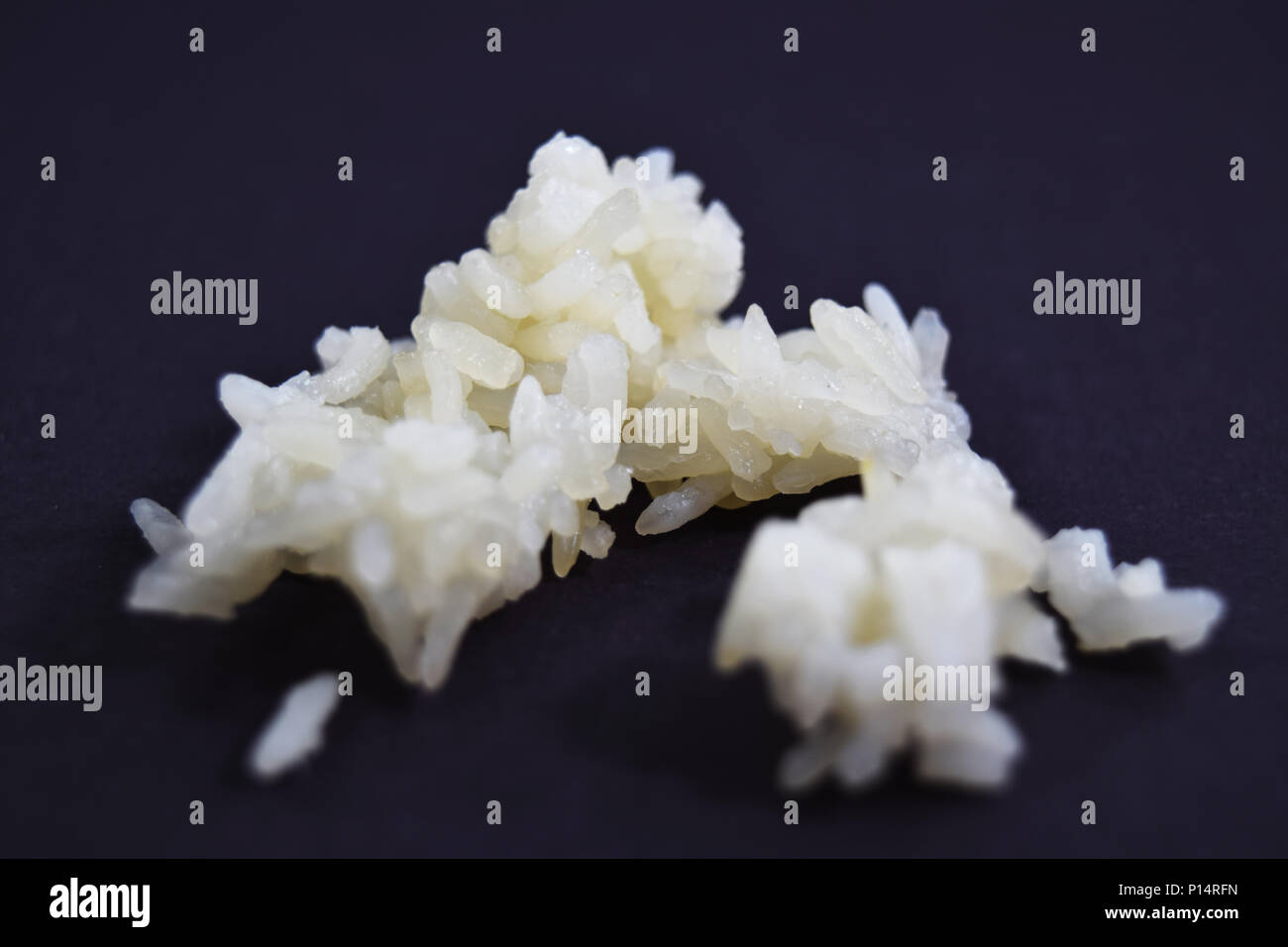 Extreme closeup (macro) of sticky glutinous rice on black background ...
