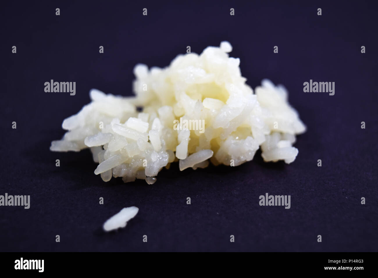 Extreme closeup (macro) of sticky glutinous rice on black background ...