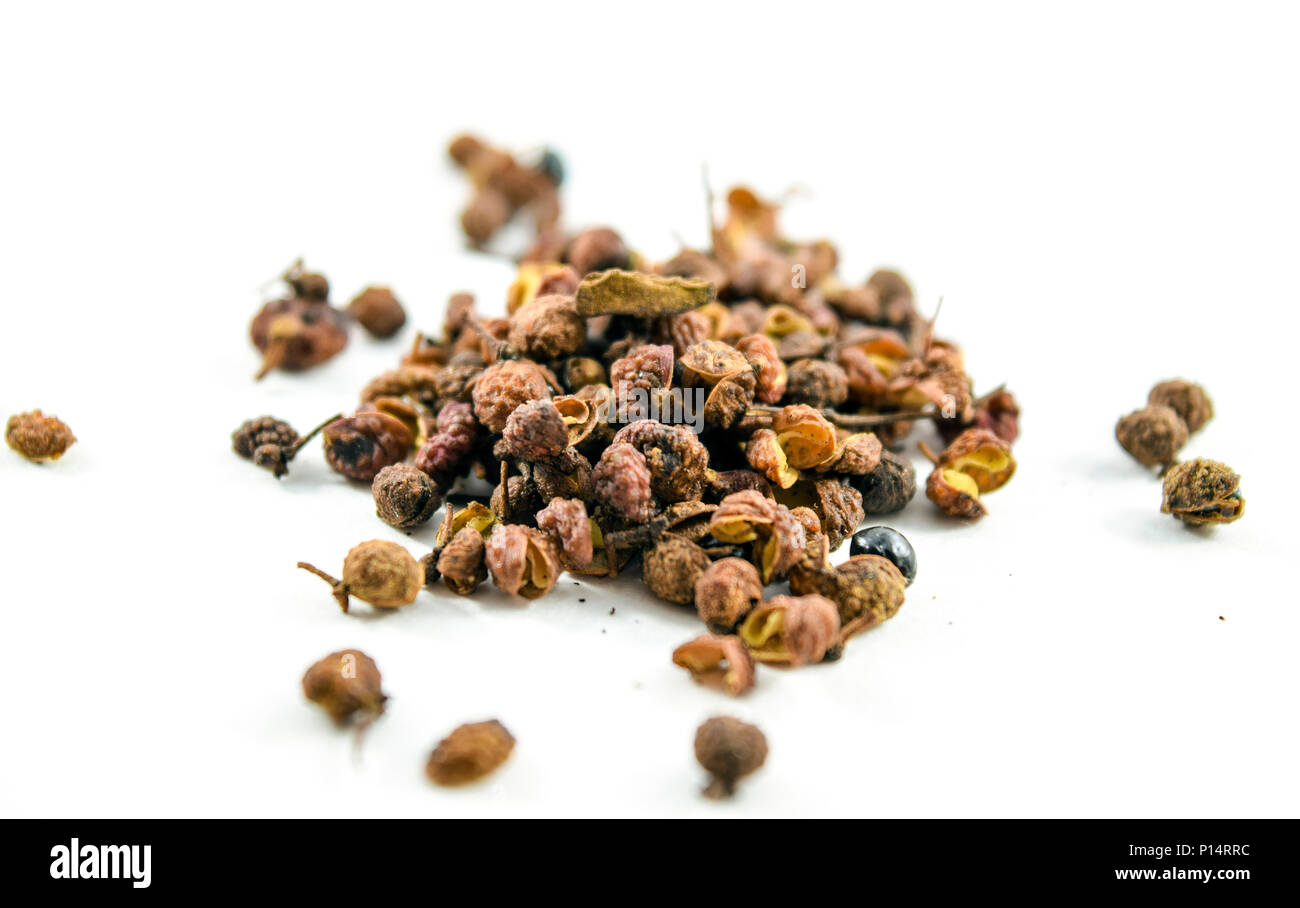 Sichuan or szechuan peppercorns isolated on white background. They numb