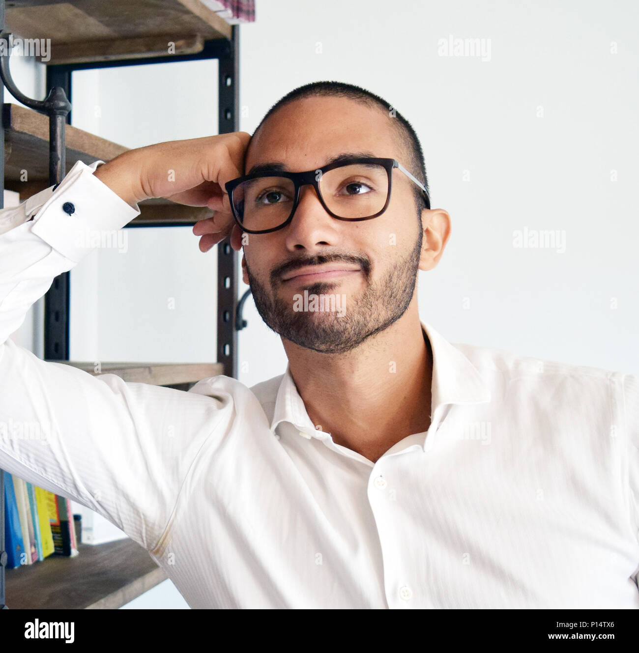 Handsome latino man with glasses thinking at office Stock Photo - Alamy