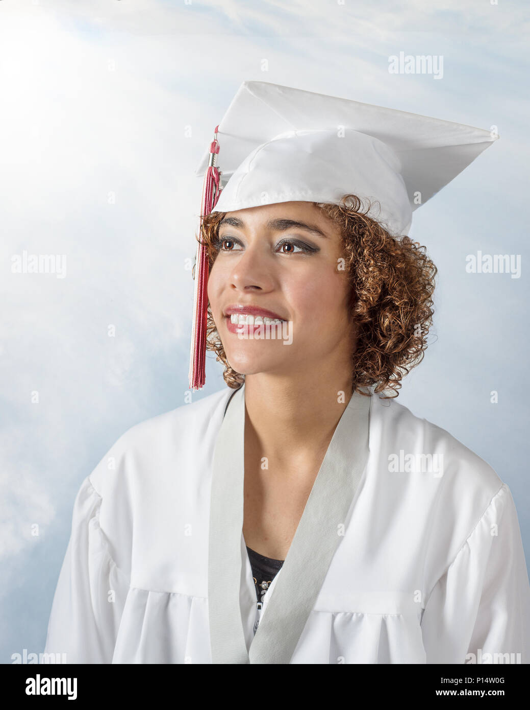 mixed race young lady with curly brown hair in a white cap and