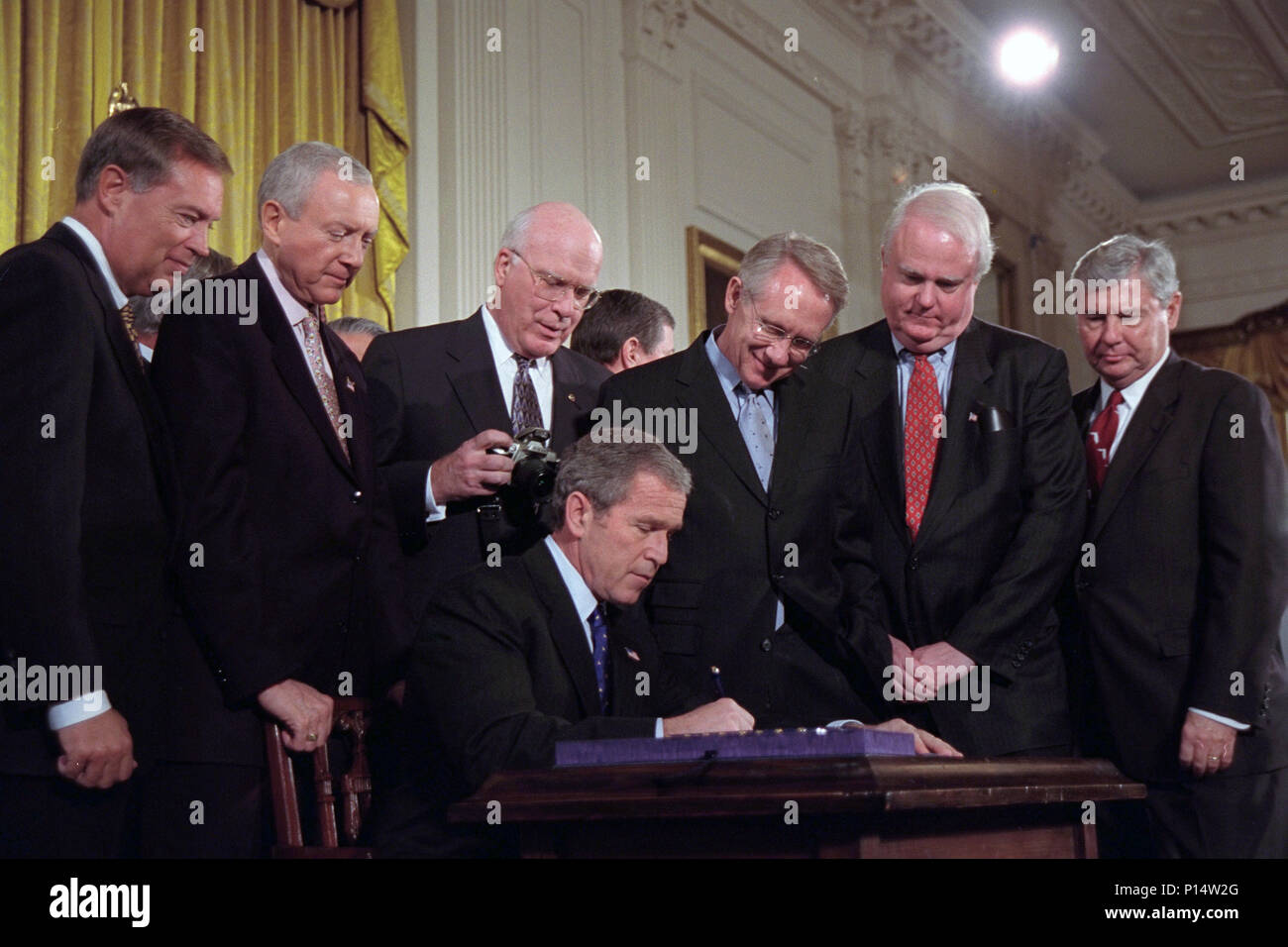 President George W. Bush signs the USA Patriot Act Friday, Oct. 26, 2001, in the East Room of the White House. Standing behind the President from left are:  U.S. Attorney General John Ashcroft;  Sen. Orrin Hatch, R-Utah;  Sen. Patrick Leahy, D-Vt; Sen. Harry Reid, D-Nev;  Rep. James Sensenbrenner of Wisconsin, and Sen. Bob Graham, D-Fla. Stock Photo
