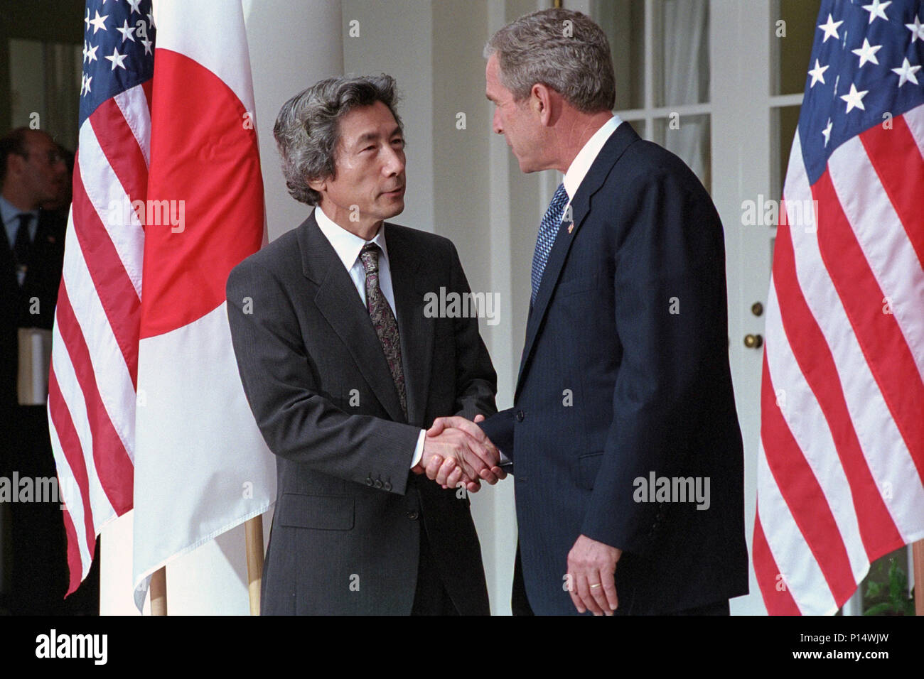 President George W. Bush shakes hands with Prime Minister Junichiro Koizumi of Japan Tuesday, Sept. 25, 2001, in the Rose Garden of the White House. Stock Photo