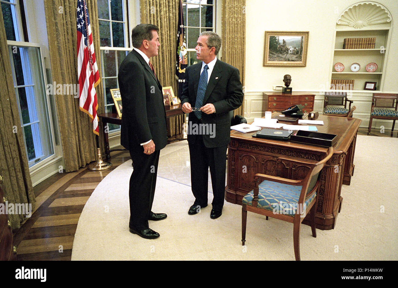 President George W. Bush talks with Pennsylvania Gov. Tom Ridge, Director of the Office of Homeland Security, Monday, Oct. 8, 2001, in the Oval Office of the White House. Stock Photo