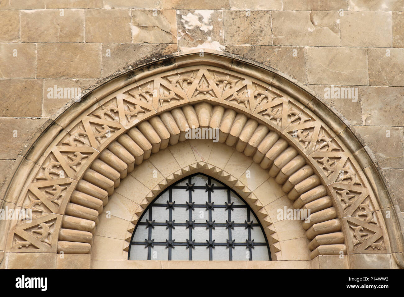 Old wall exterior with decorative arch and small window Stock Photo - Alamy