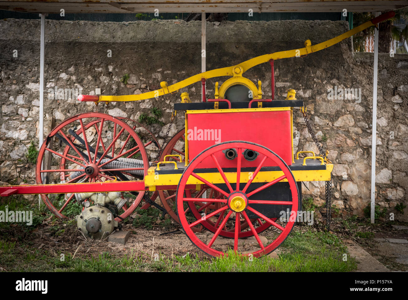 Old vintage manual red yellow pump of fire brigade in Croatia Stock Photo