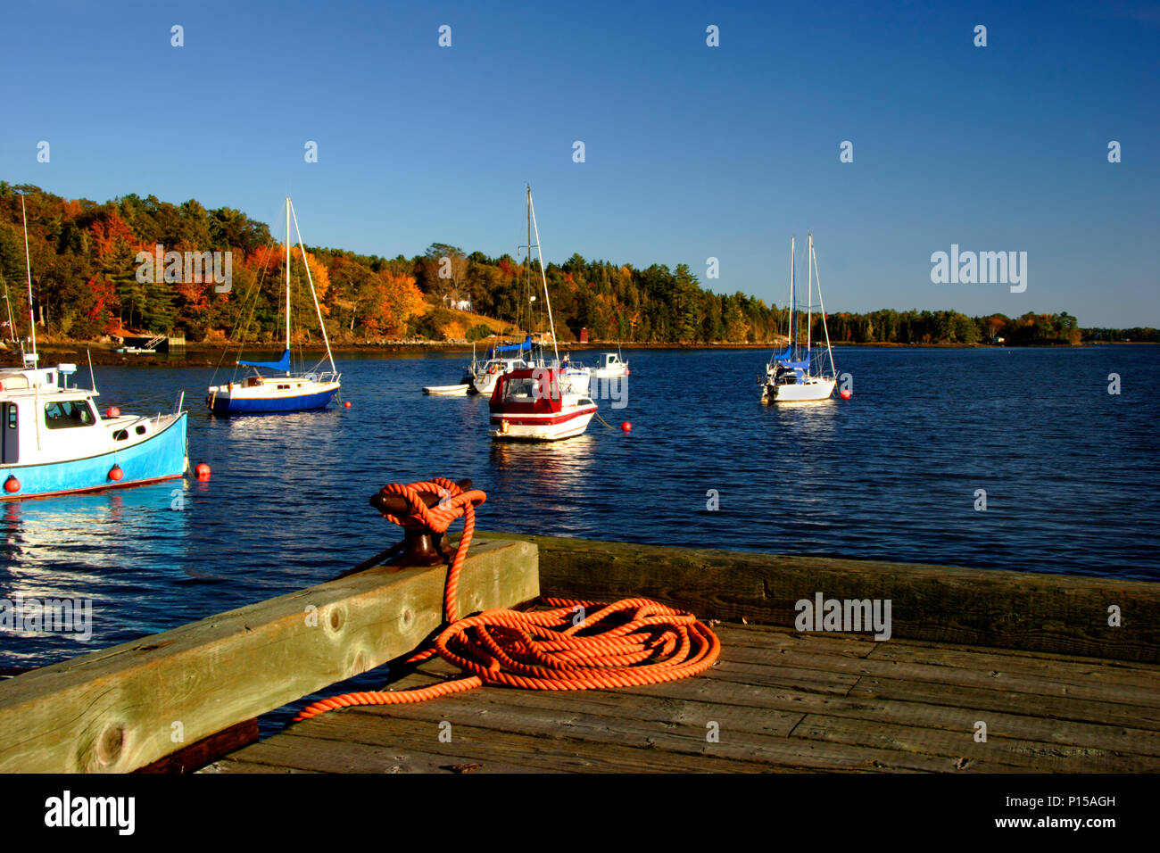 Fishing and pleasure boats by a wharf in the autumn Stock Photo