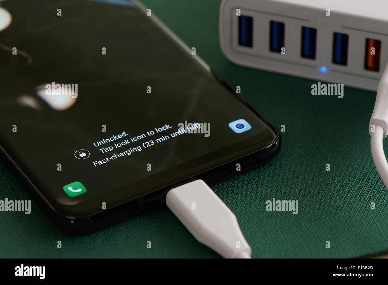 multiport charging station and fast-charging smartphone with notification Stock Photo