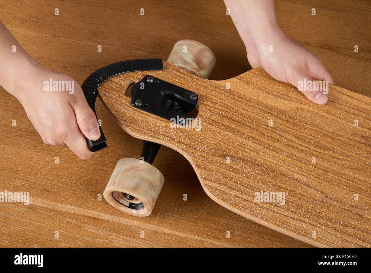 Installing a guard for longboard nose protection Stock Photo - Alamy