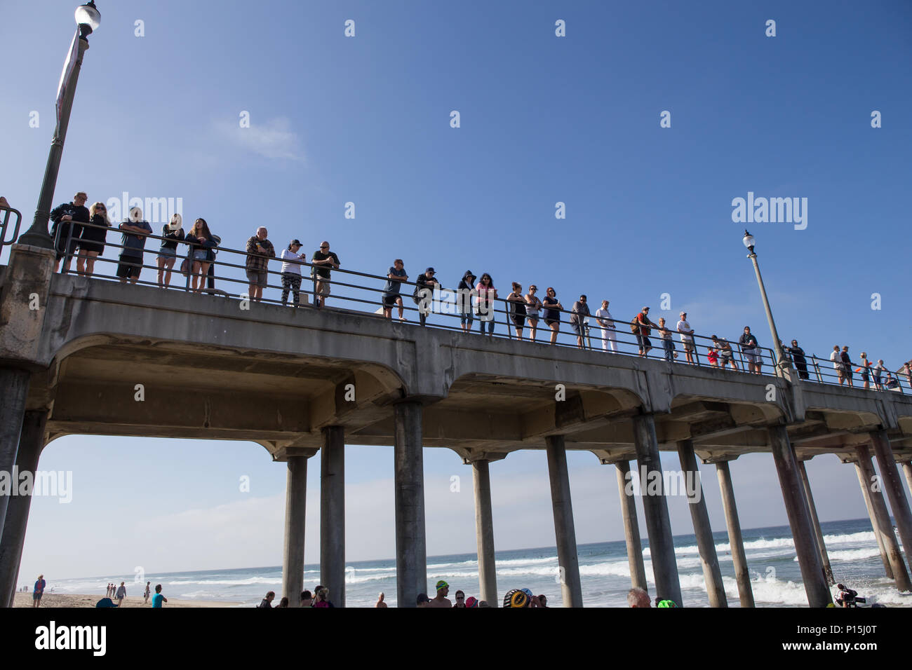 Spectators line Huntington Beach Pier for the start of the pier swim