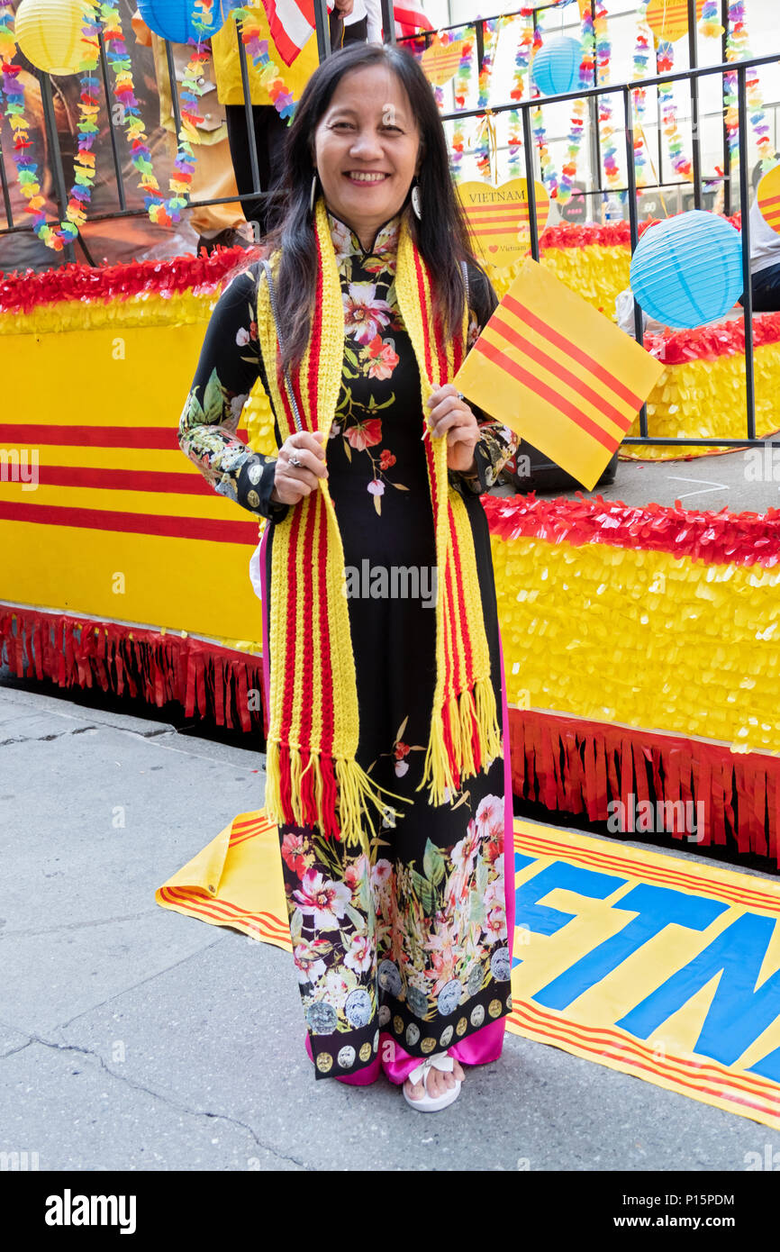 An immigrant wearing a South Vietnam scarf and waving a South Vietnamese flag at the Vietnamese American Cultural Parade. Stock Photo