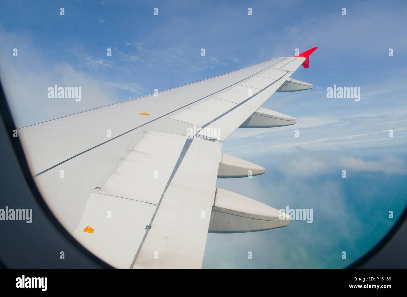 Airplane wing in the blue sky with white clouds Stock Photo - Alamy