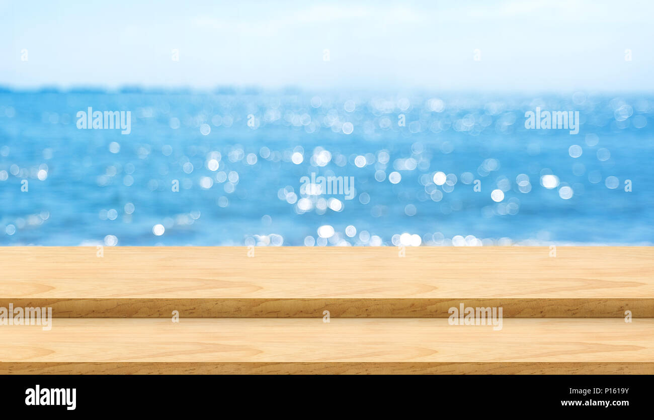 Empty Plank Wood Table Top With Blur Blue Sky And Sea Bokeh