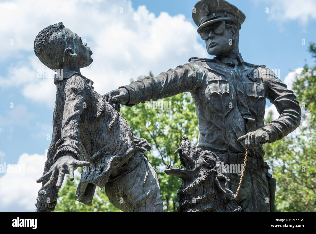 The Foot Soldier sculpture at Kelly Ingram Park in Birmingham, AL depicts  a 1963 confrontation between black protesters and police with attack dogs. Stock Photo