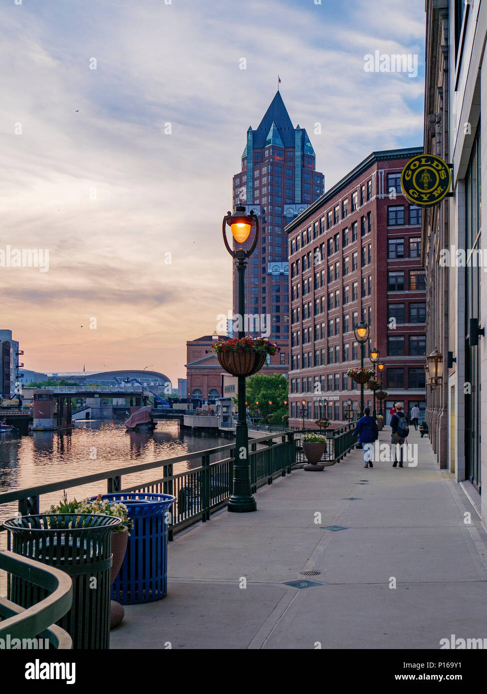 Milwaukee Riverwalk and buildings. Evening. Stock Photo