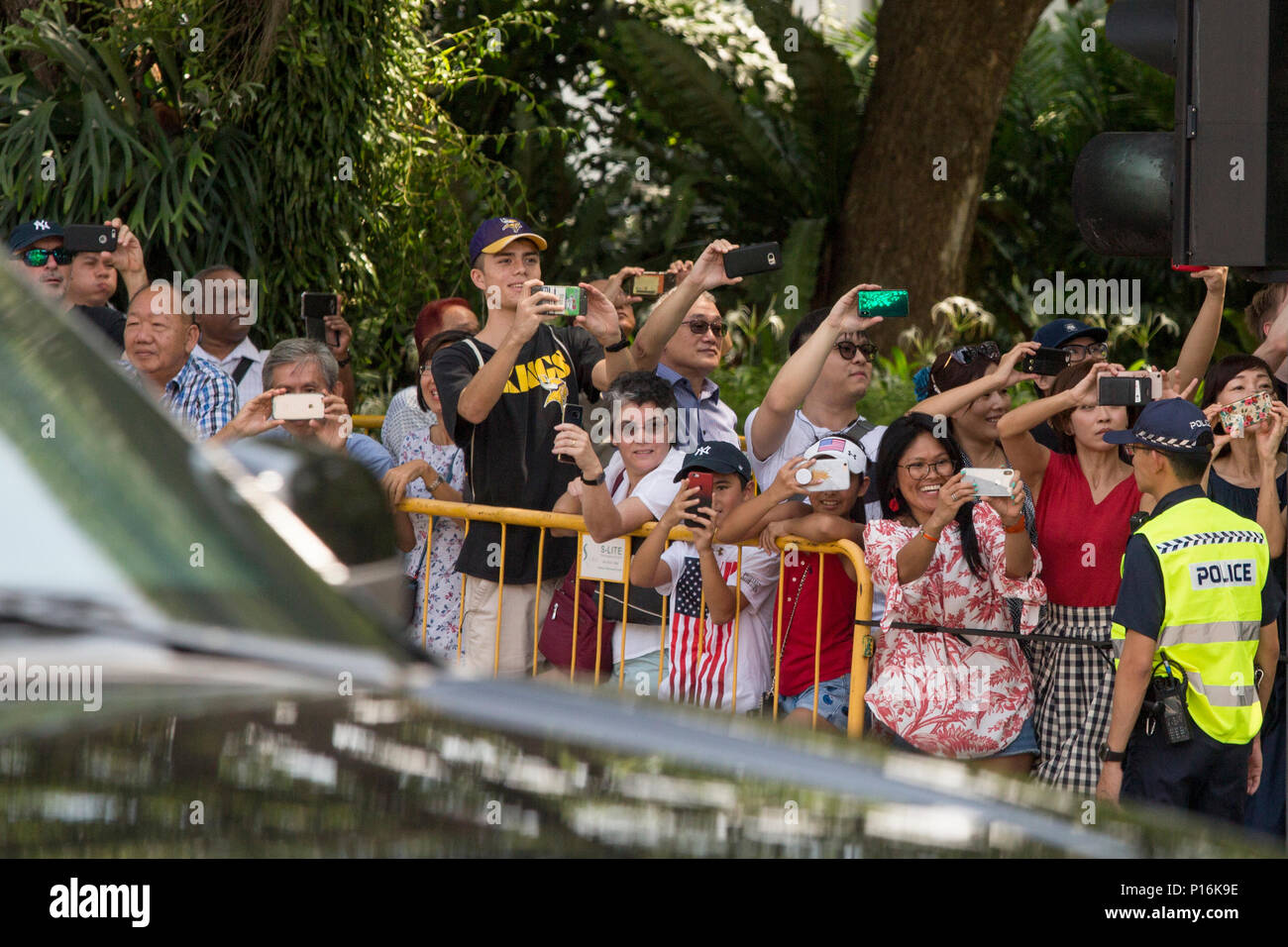 People gathered in front of the Istana are watching US President's Donald Trump motorcade entering the gate. Singapore Prime Minister Lee Hsien Loong and US President Donald Trump have a private meeting and a lunch ahead of the DPRK-US summit which is scheduled for June 12th. Stock Photo